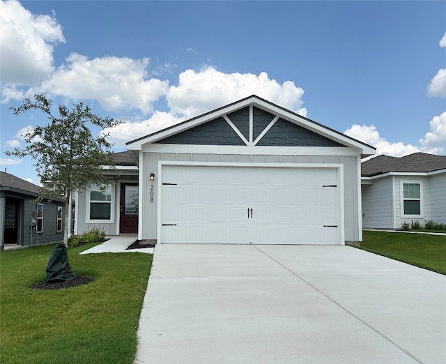 view of front of property featuring a garage and a front lawn