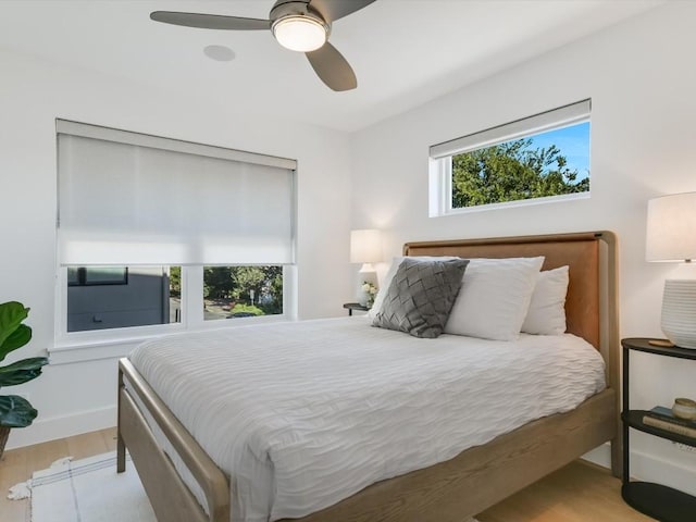 bedroom with light hardwood / wood-style flooring and ceiling fan