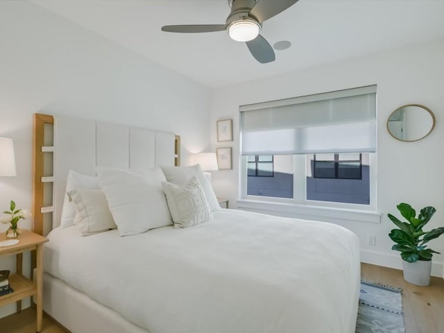 bedroom with wood-type flooring and ceiling fan