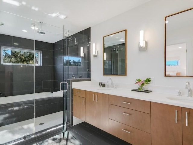 bathroom with tile patterned flooring, vanity, and a shower with door