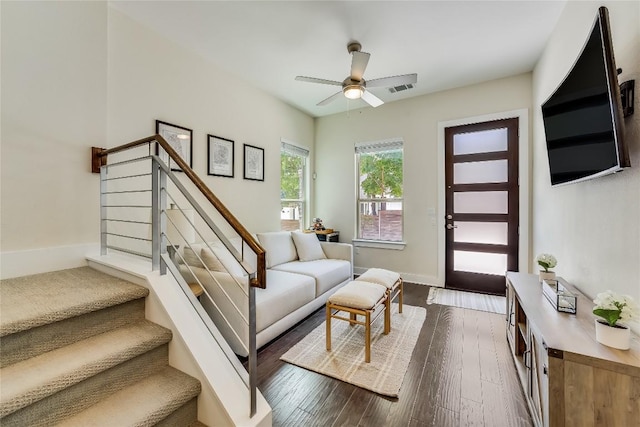 living room featuring dark hardwood / wood-style flooring and ceiling fan