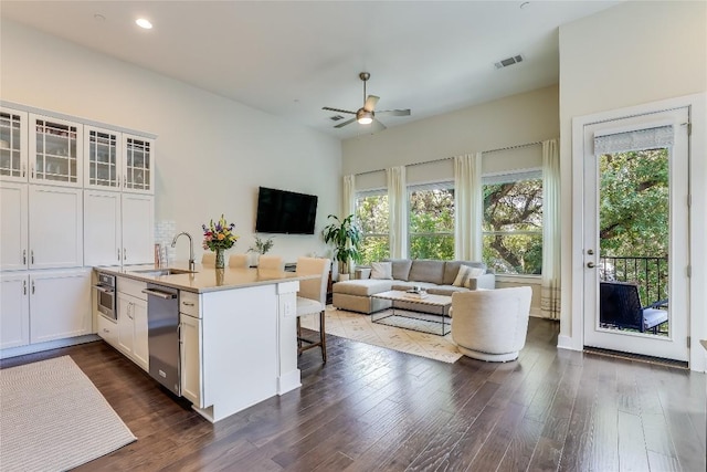 kitchen featuring appliances with stainless steel finishes, white cabinetry, sink, and a breakfast bar area