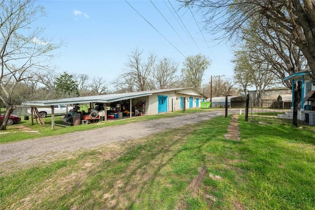 view of front facade featuring a front lawn and a carport