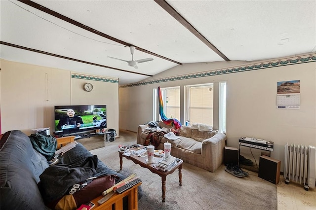 living room with hardwood / wood-style flooring, ceiling fan, lofted ceiling, and radiator