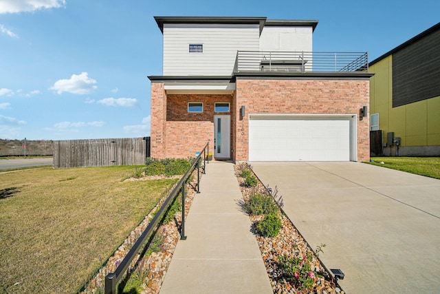 view of front facade featuring a garage, a front lawn, and a balcony