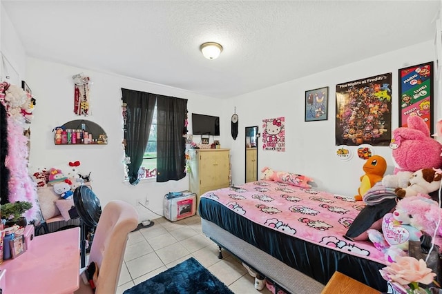 bedroom with light tile patterned floors and a textured ceiling