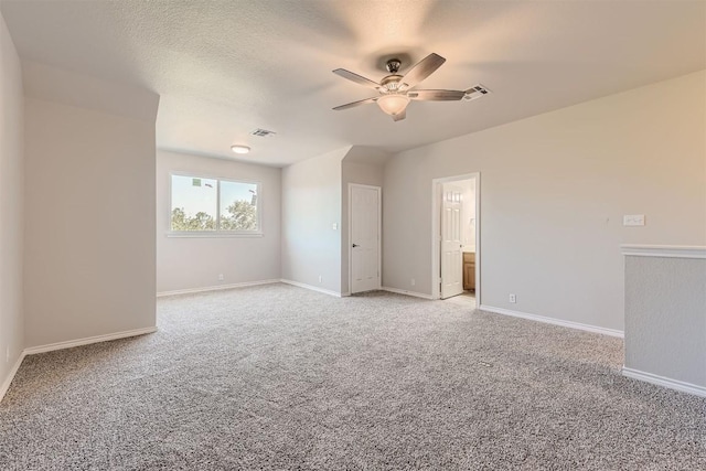 empty room with ceiling fan and carpet floors