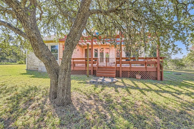 back of property featuring a lawn and a wooden deck