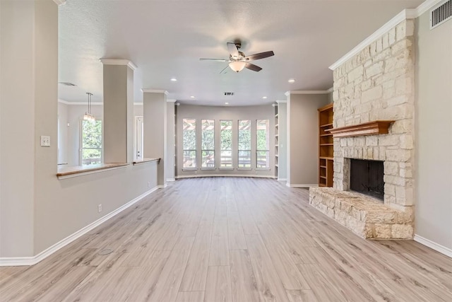 unfurnished living room featuring crown molding, a fireplace, and a healthy amount of sunlight