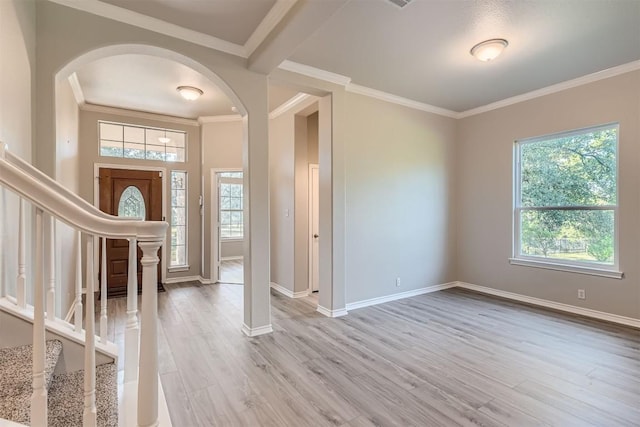 foyer entrance featuring crown molding and light hardwood / wood-style floors