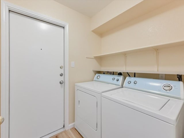 laundry area featuring light hardwood / wood-style floors and separate washer and dryer