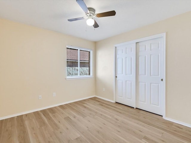 unfurnished bedroom with a closet, light hardwood / wood-style flooring, and ceiling fan