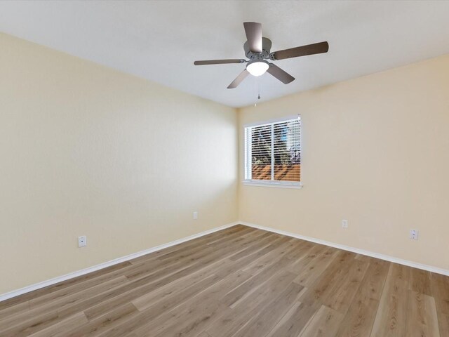 unfurnished room with ceiling fan and light hardwood / wood-style floors