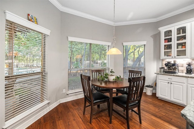 dining room with crown molding and dark hardwood / wood-style flooring