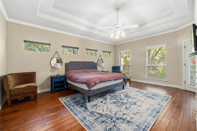 bedroom with dark hardwood / wood-style floors, a raised ceiling, ceiling fan, and crown molding