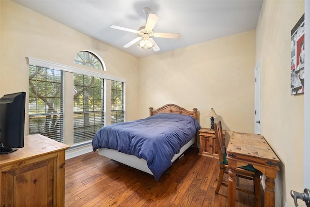 bedroom with ceiling fan and dark hardwood / wood-style flooring