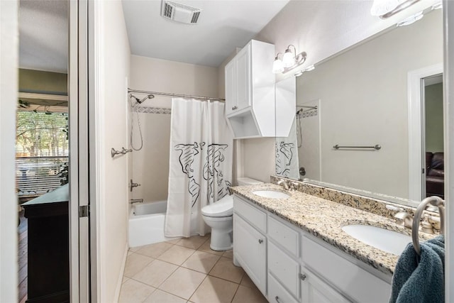 full bathroom with tile patterned floors, shower / bath combination with curtain, toilet, and vanity