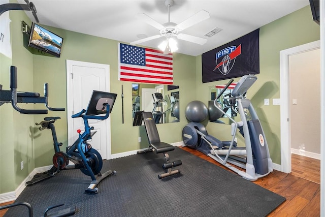 exercise room with ceiling fan and dark hardwood / wood-style flooring