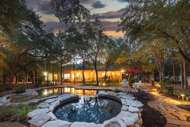 204 Woodland Park, Georgetown, TX 78633 - pool at dusk with a pool with connected hot tub and a patio