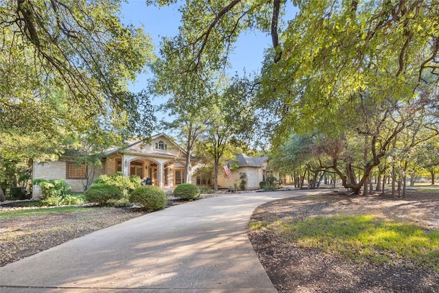 204 Woodland Park, Georgetown, TX 78633 - view of front facade with covered porch, stone siding, and concrete driveway