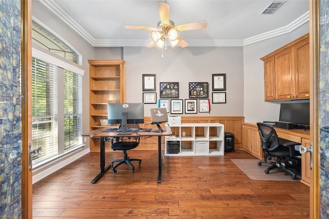 office with ceiling fan, plenty of natural light, dark wood-type flooring, and ornamental molding