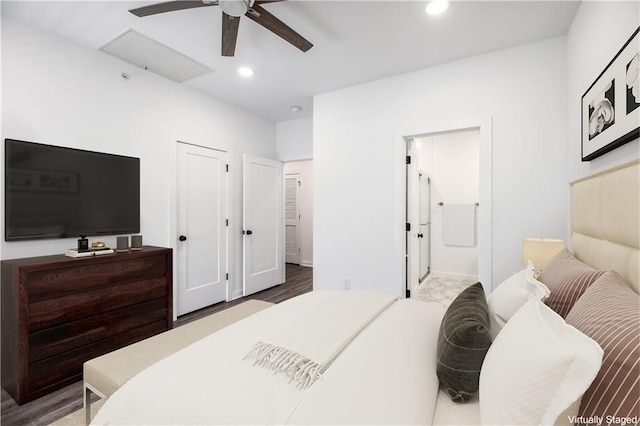 bedroom with ensuite bath, ceiling fan, and hardwood / wood-style flooring