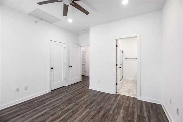 unfurnished bedroom with dark hardwood / wood-style floors, connected bathroom, and ceiling fan