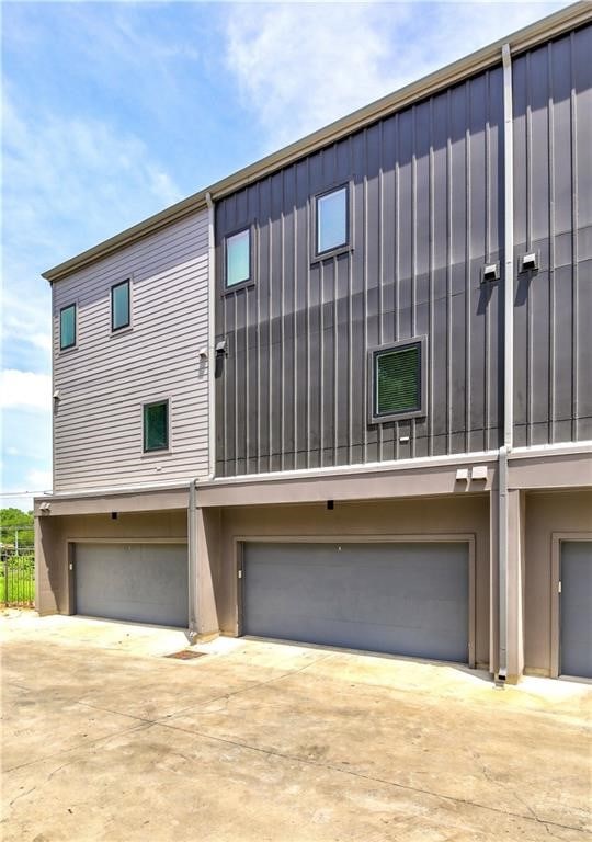 view of front of home with a garage, driveway, and board and batten siding