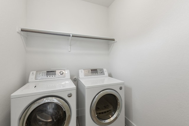 clothes washing area featuring independent washer and dryer