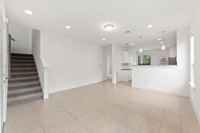 unfurnished living room with light tile patterned flooring