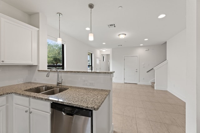 kitchen featuring white cabinetry, sink, stainless steel dishwasher, and light stone counters