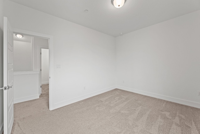 empty room featuring light colored carpet