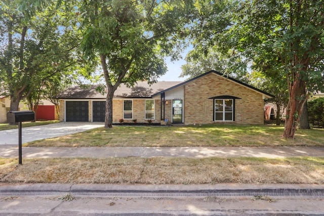 ranch-style home featuring a front lawn and a garage