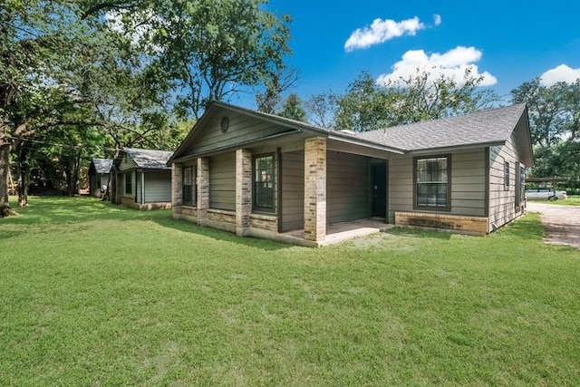 rear view of property featuring a lawn