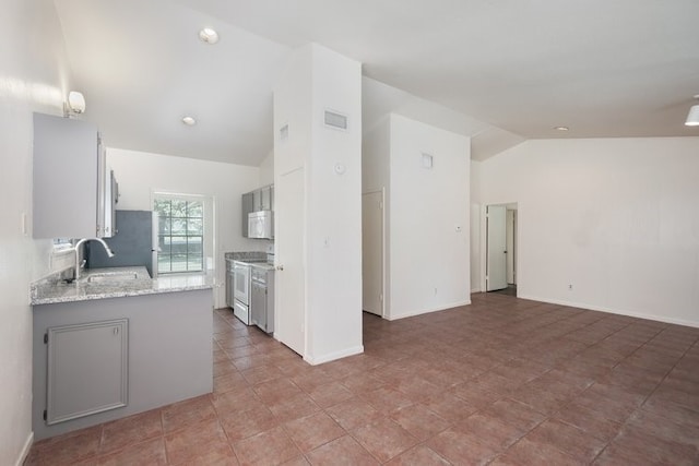 kitchen with white cabinetry, sink, kitchen peninsula, vaulted ceiling, and white appliances