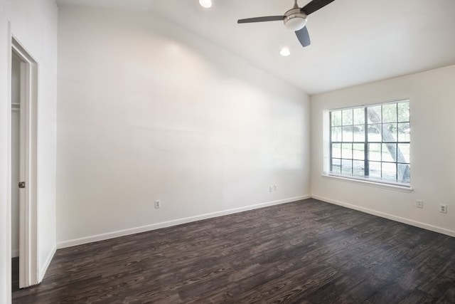 empty room with ceiling fan, dark hardwood / wood-style flooring, and lofted ceiling