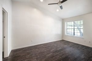 unfurnished room with dark hardwood / wood-style flooring, ceiling fan, and lofted ceiling