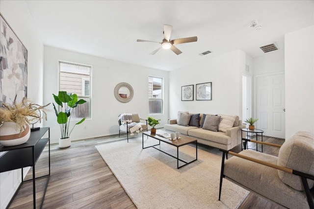 living room with ceiling fan and light hardwood / wood-style floors