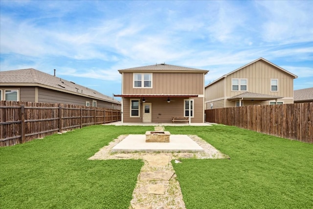 back of property featuring an outdoor fire pit, ceiling fan, a patio area, and a lawn