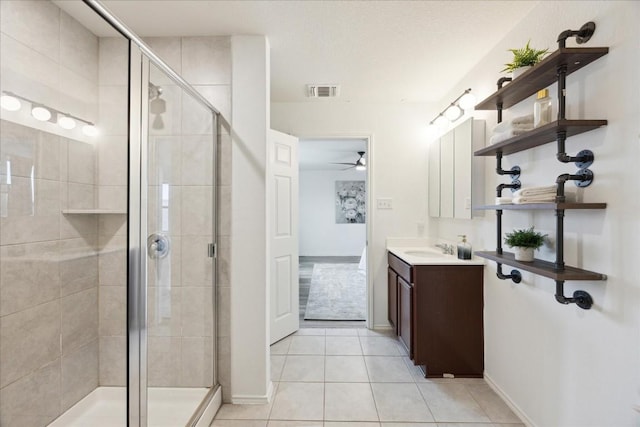 bathroom with vanity, a shower with door, tile patterned floors, and ceiling fan