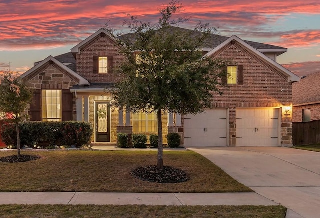 front of property featuring a yard and a garage