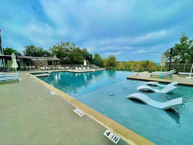 view of swimming pool featuring a patio area