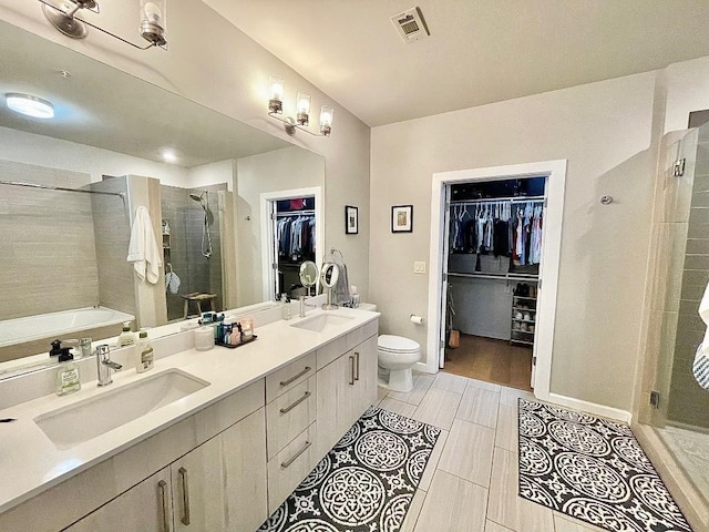 full bathroom with vanity, independent shower and bath, and toilet