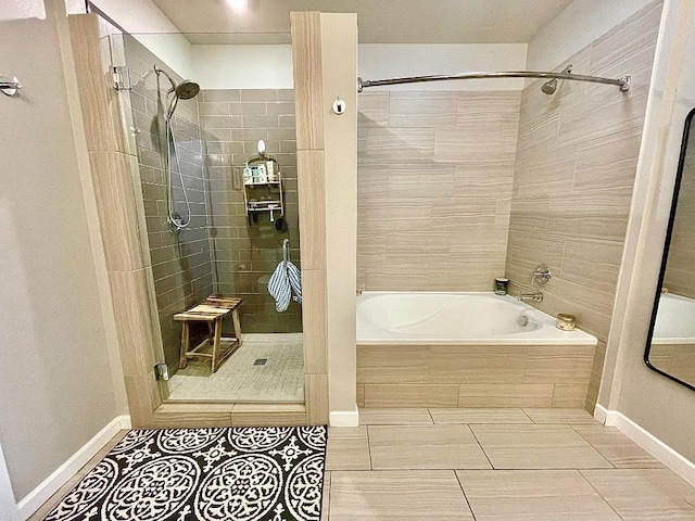 bathroom featuring tile patterned flooring and separate shower and tub