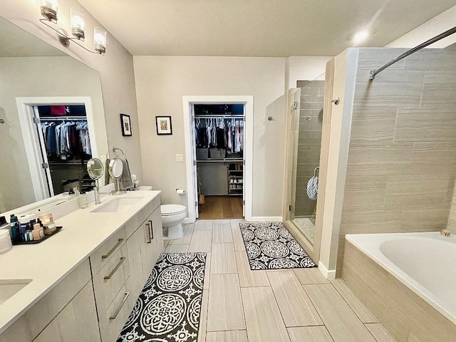 full bathroom featuring vanity, plus walk in shower, and toilet