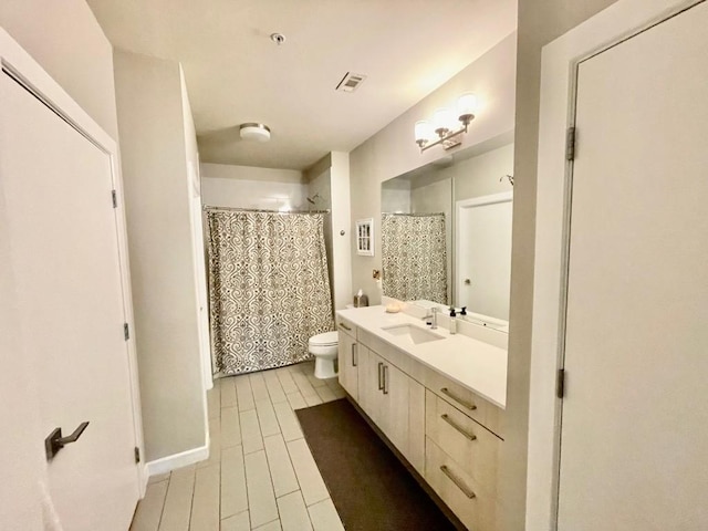 bathroom featuring curtained shower, vanity, and toilet