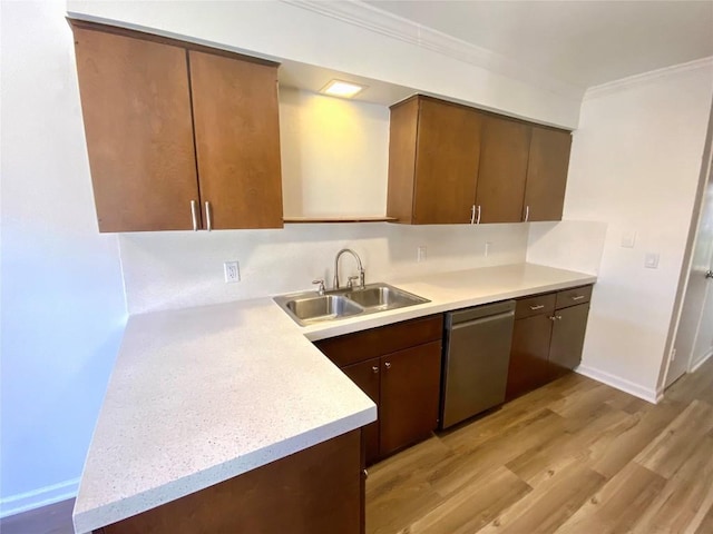 kitchen with dishwasher, light wood-type flooring, ornamental molding, and sink