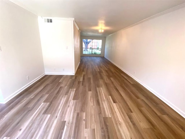 spare room with crown molding and dark hardwood / wood-style floors