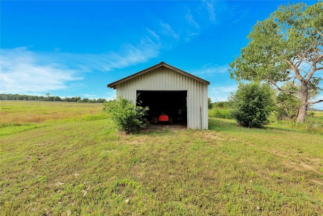 view of outdoor structure with a lawn and a rural view