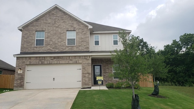 view of front of house with a garage and a front yard